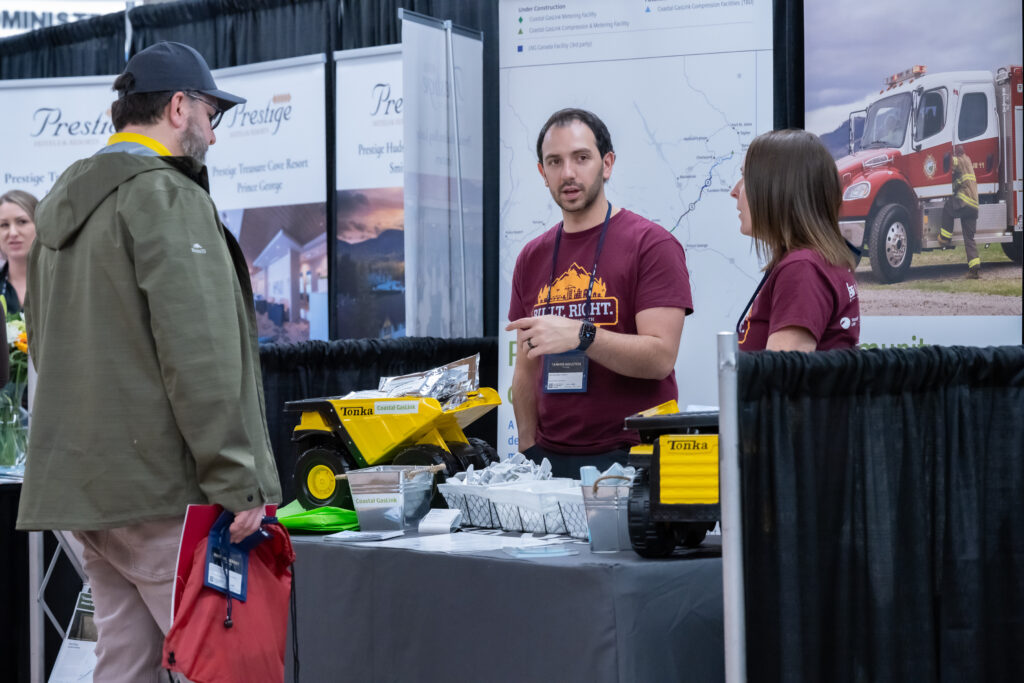 Image of three people having a conversation at a tradeshow