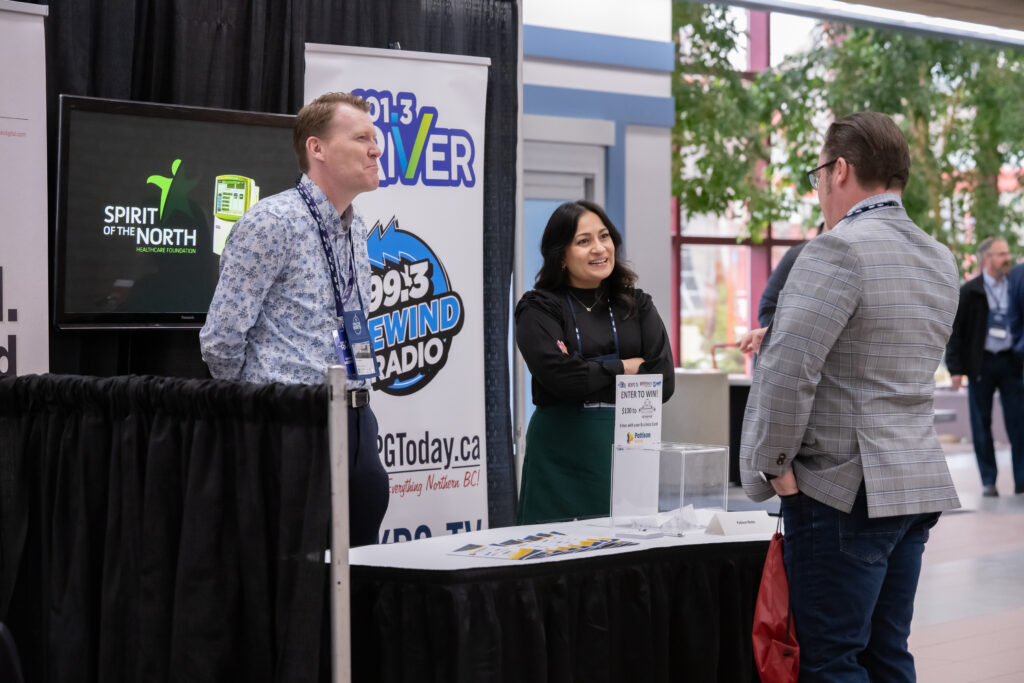 Image of three people having a conversation at a tradeshow