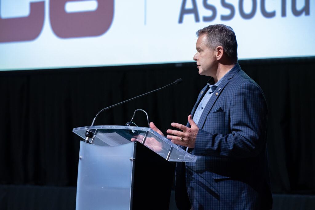 Image of man speaking on stage