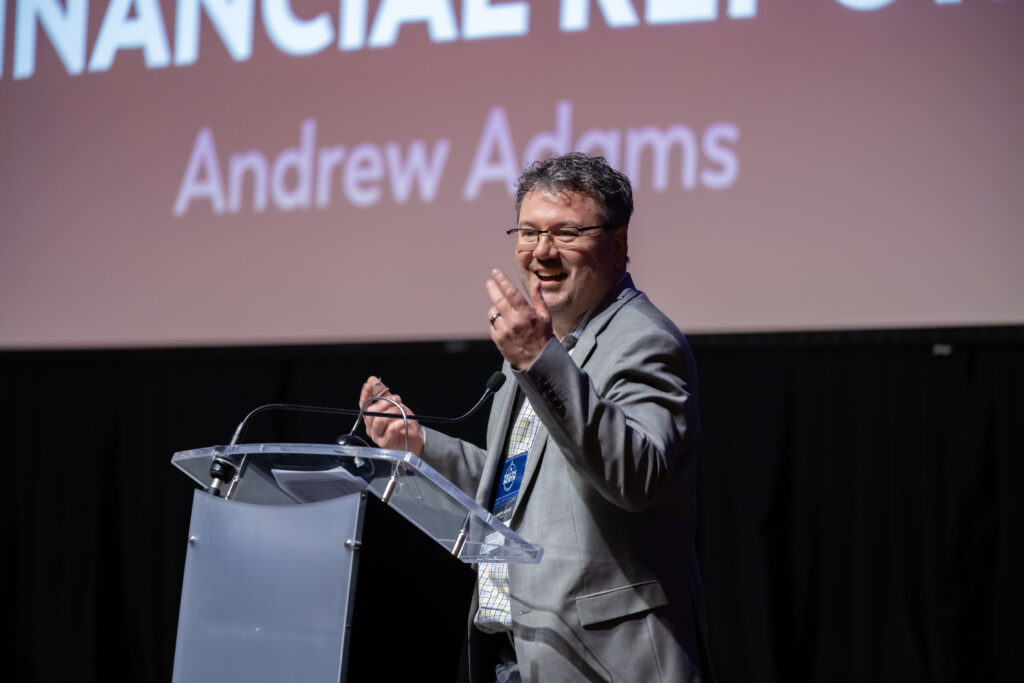 Image of man speaking on stage